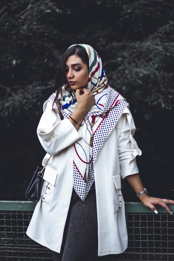 Stylish woman in Tehran, Iran wearing an elegant headscarf and blazer outdoors.